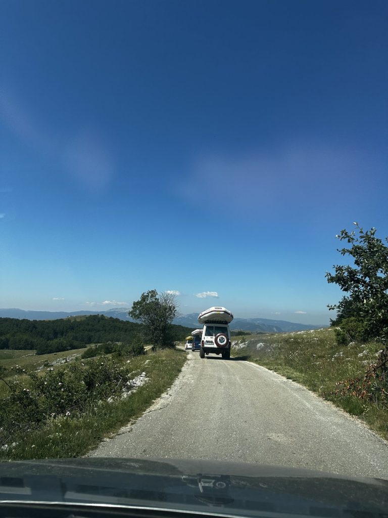 Geländewagen mit Raftingbooten auf dem Dach auf der Straße des Durmitor-Rings